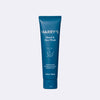 Blue tube of Harry's beard and face wash on a light gray background