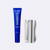Blue tube of Harry's eye cream and a silver  Facial Massage Tool on a white background