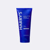 Blue tube of Harry's Exfoliating Facial Cleanser on a light gray background